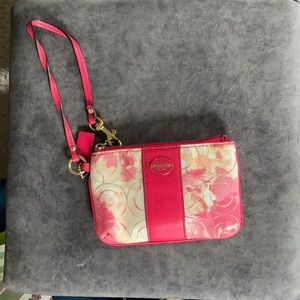 Pink, orange, and cream-colored Coach wristlet